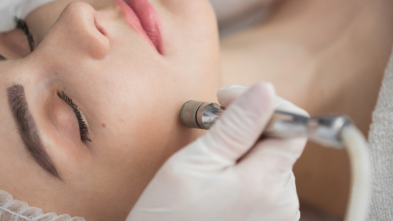 Woman receiving professional microdermabrasion facial treatment