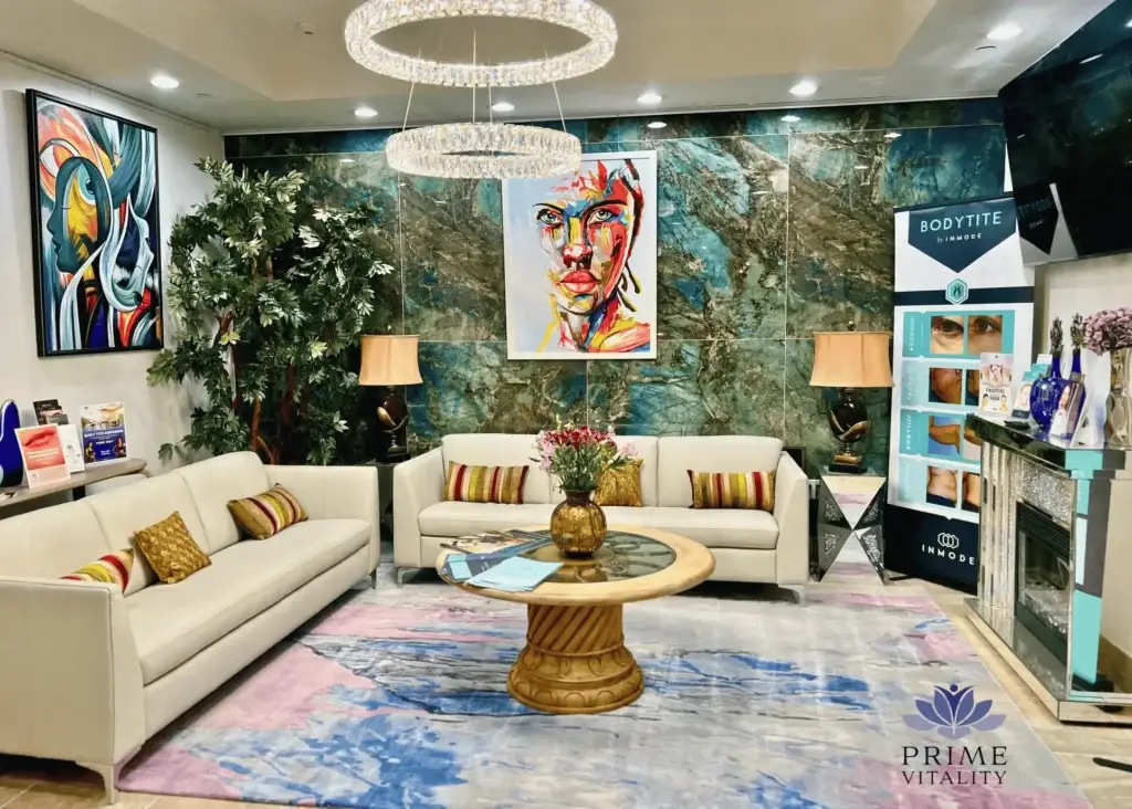 Modern waiting area with plush sofas, artwork, and decorative plants.
