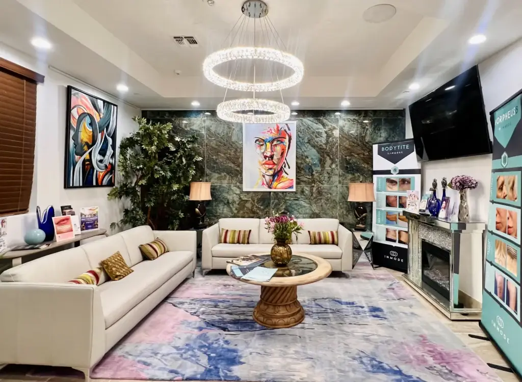 Modern waiting area featuring a colorful painting, plush sofas, and a decorative rug.
